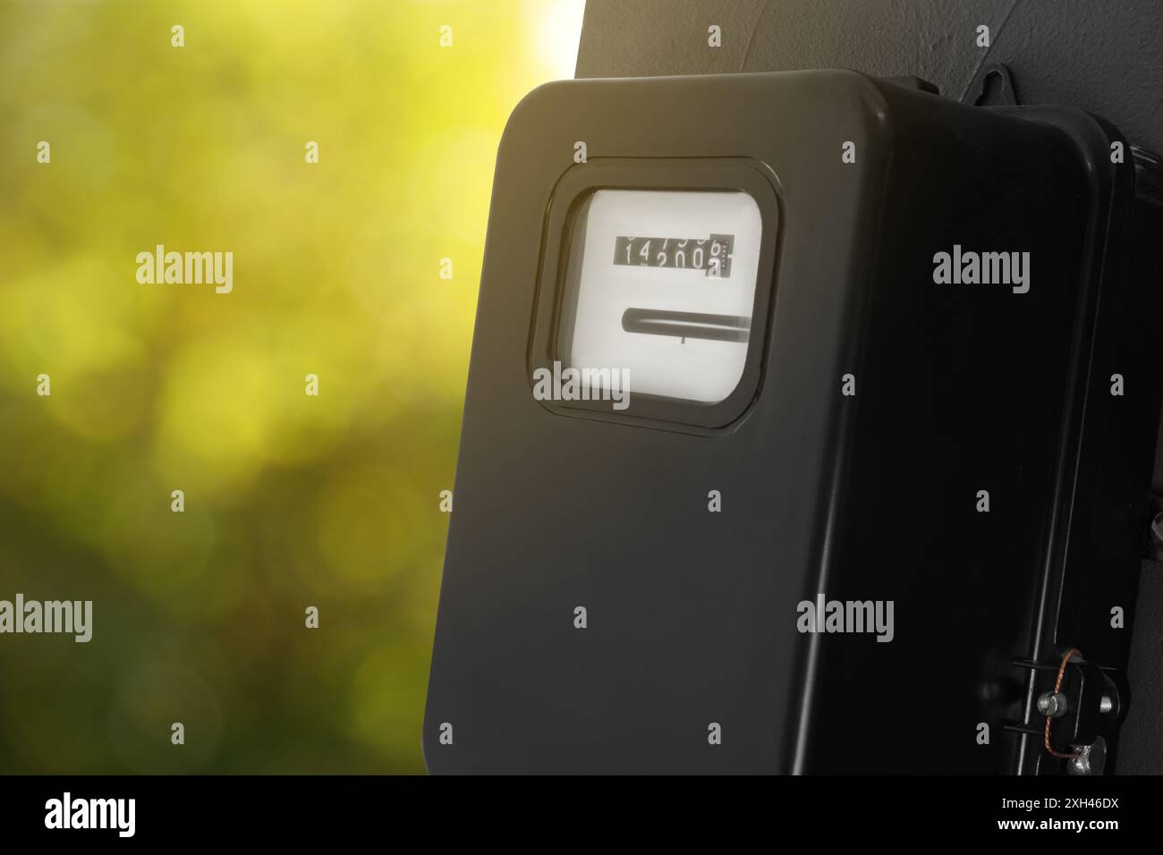 Electricity meter on wall outdoors, space for text. Measuring device Stock Photo