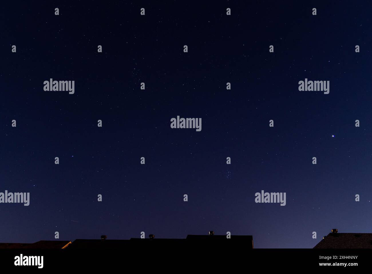 Starry night sky over urban silhouette - celestial display meets cityscape. Taken in Toronto, Canada. Stock Photo