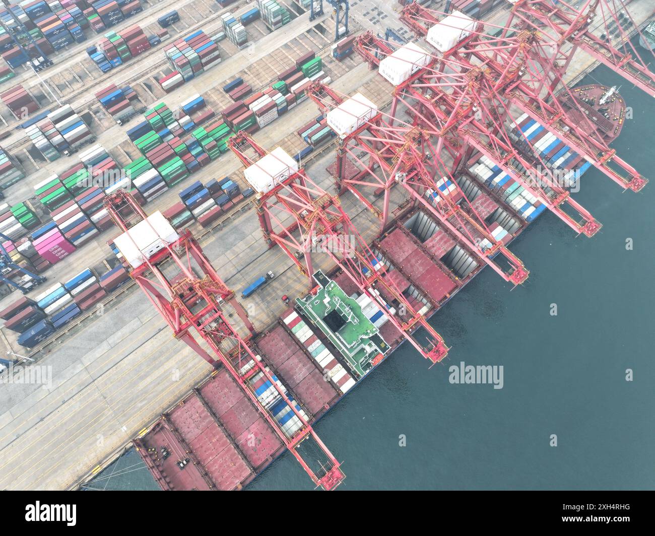 LIANYUNGANG, CHINA - JULY 12, 2024 - Cargo ships dock at the berth for ...