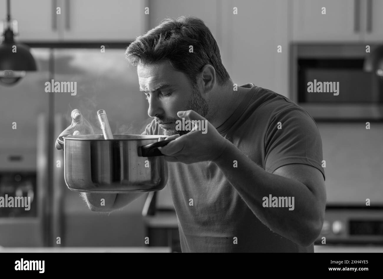 Man cook cooking at kitchen. Chef cook man prepares a dish with food in ...
