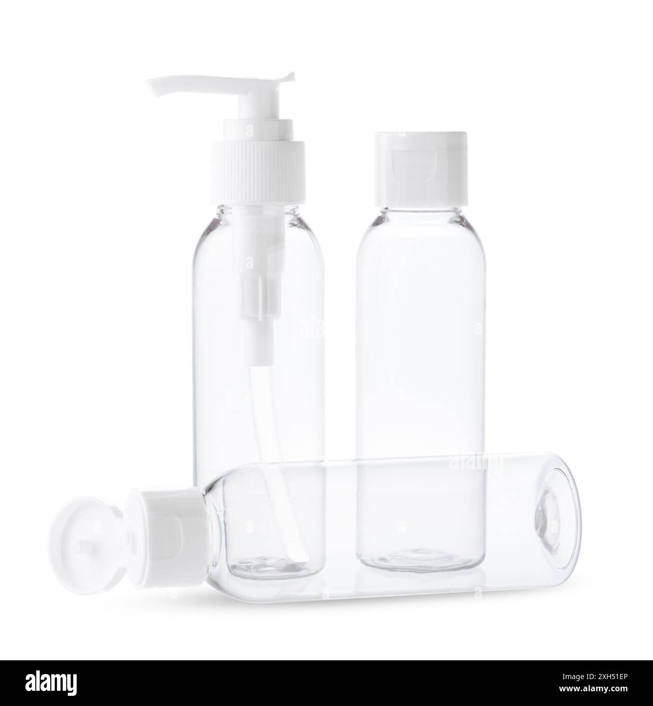 Three Clear Plastic Bottles With White Caps and Pumps on a White ...