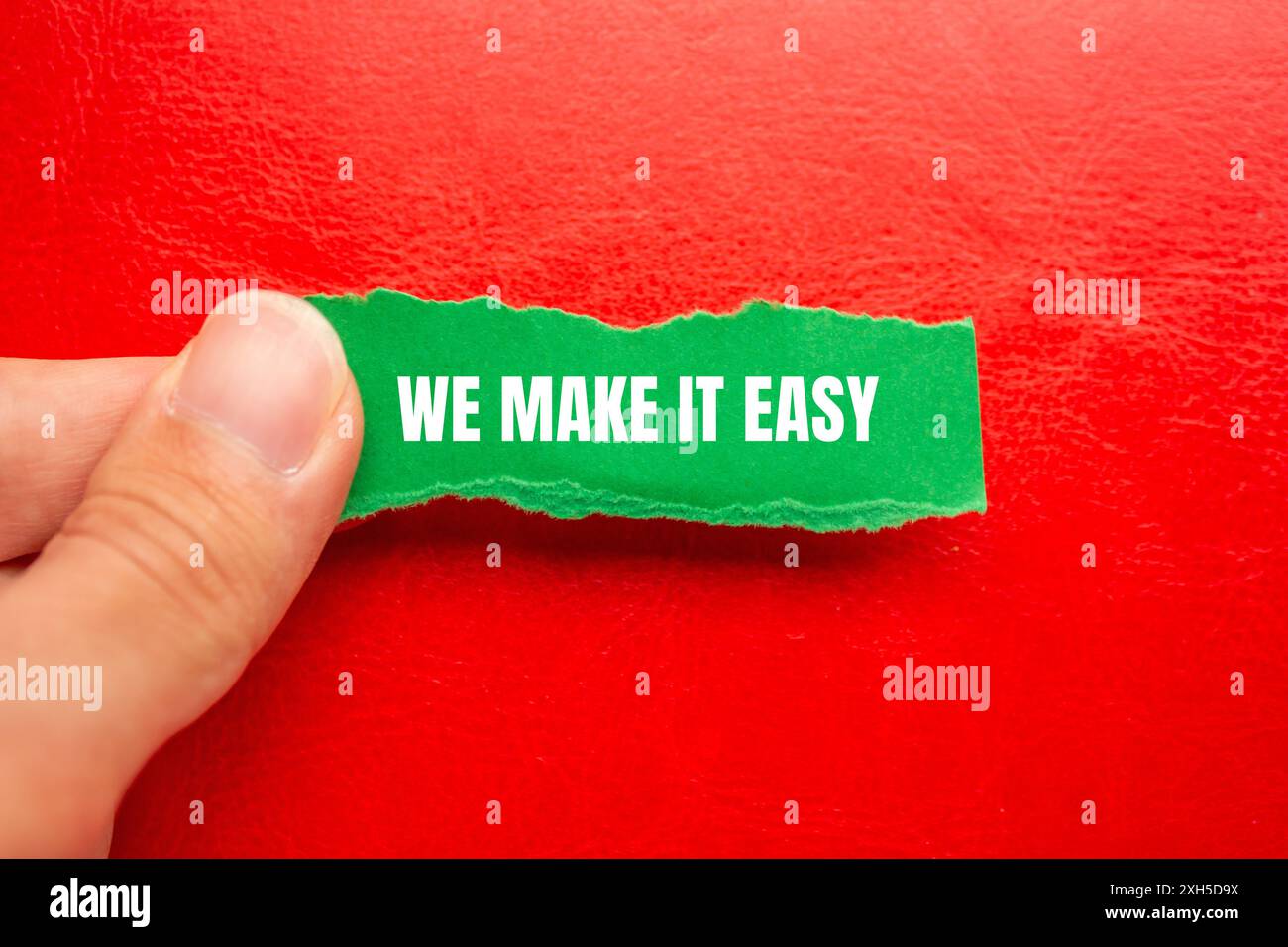 We make it easy message written on ripped torn green paper with red ...