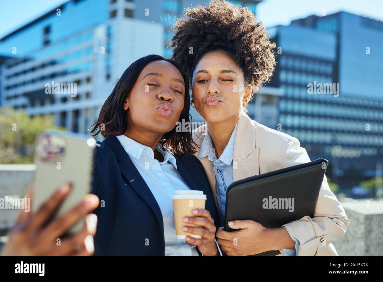 Diverse Entrepreneurs Taking a Selfie in Urban Setting with Coffee and Laptop Stock Photo