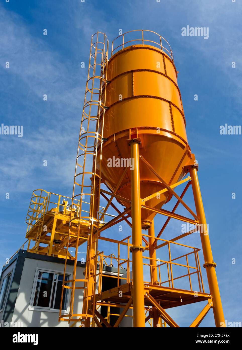 Construction site equipment, generic asphalt or concrete plant, outdoors low angle shot, blue sky background Stock Photo