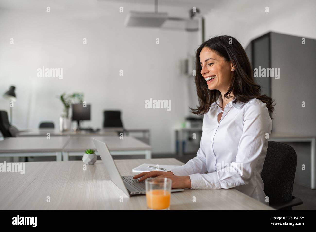 Joyfull office worker typing on computer Stock Photo