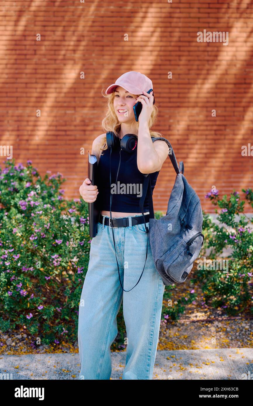 Student talking on phone outside Stock Photo