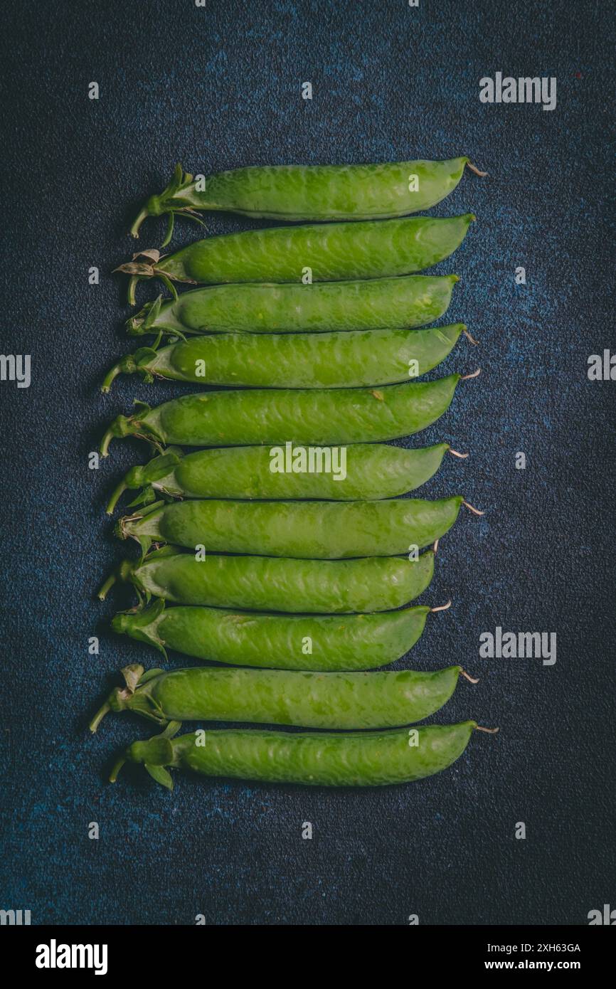 Green peas on dark blue background Stock Photo