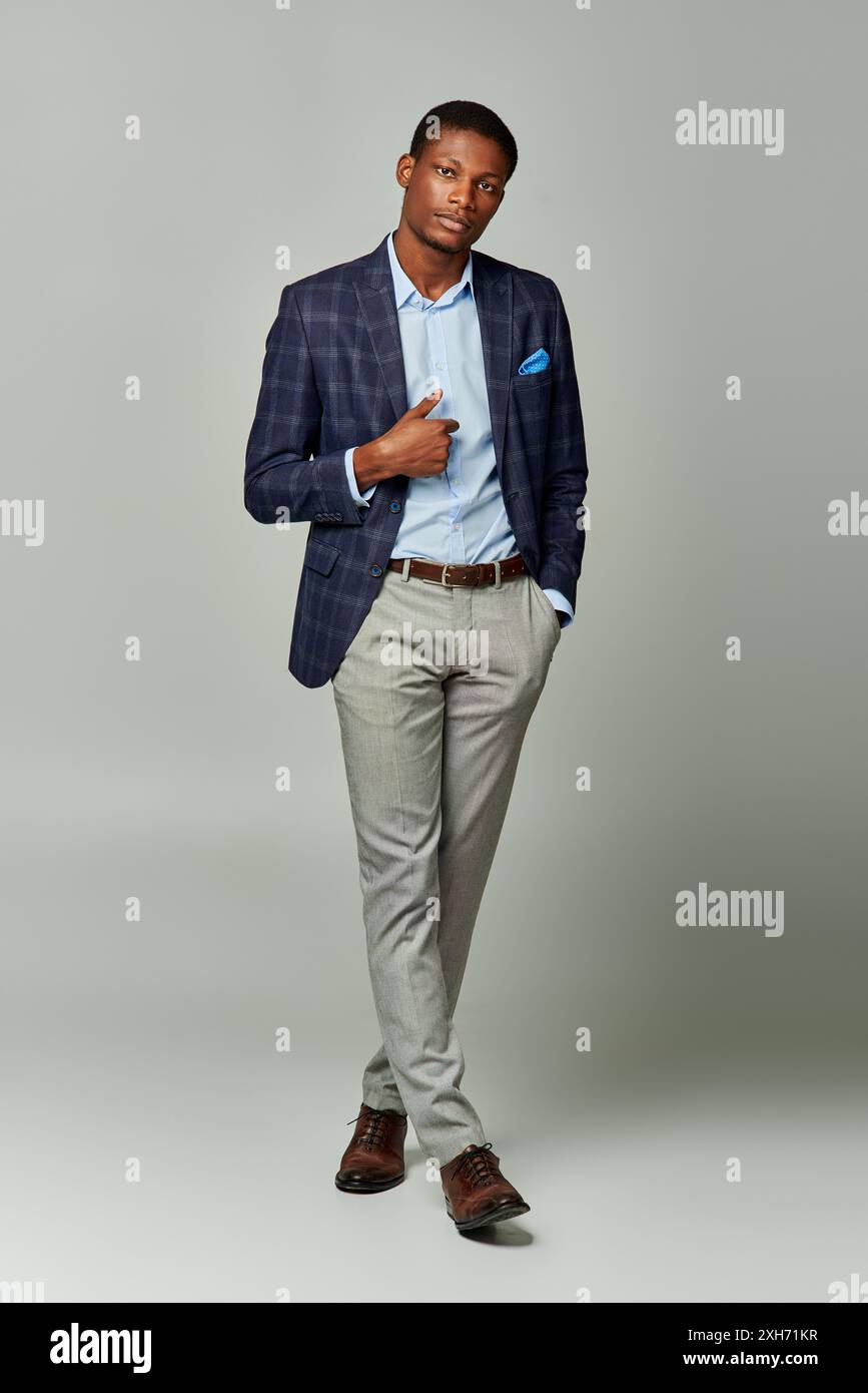 A handsome African American man in a suit and tie striking a pose ...