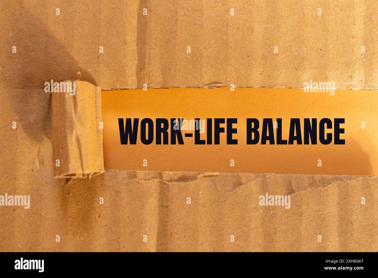 Work life balance message written on ripped torn cardboard paper with ...