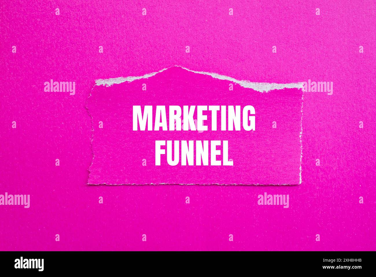 Marketing funnel message written on ripped torn pink paper piece with ...