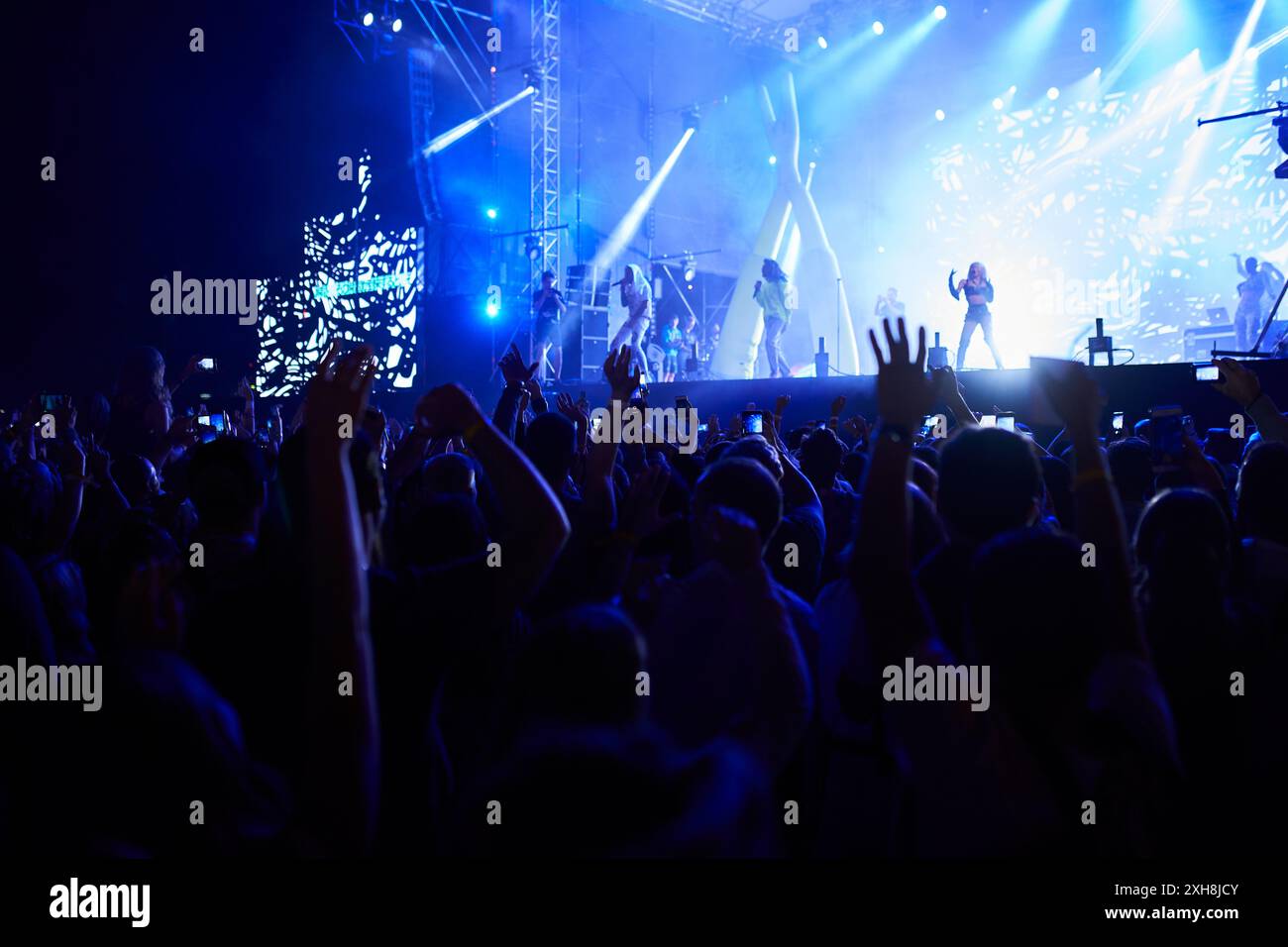 Energetic crowd concert goers raise hi-res stock photography and images ...