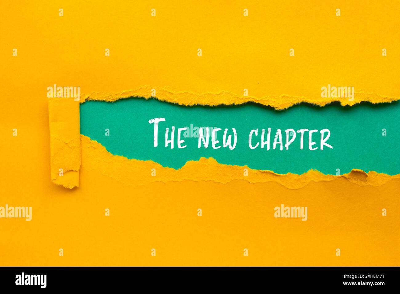 The new chapter message written on ripped torn yellow paper with blue ...