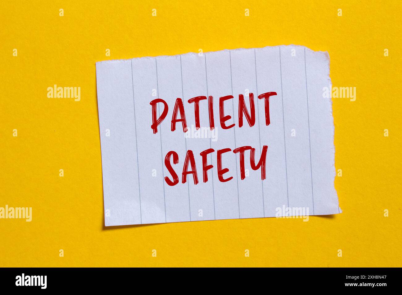 Patient safety message written on ripped torn white paper piece with ...