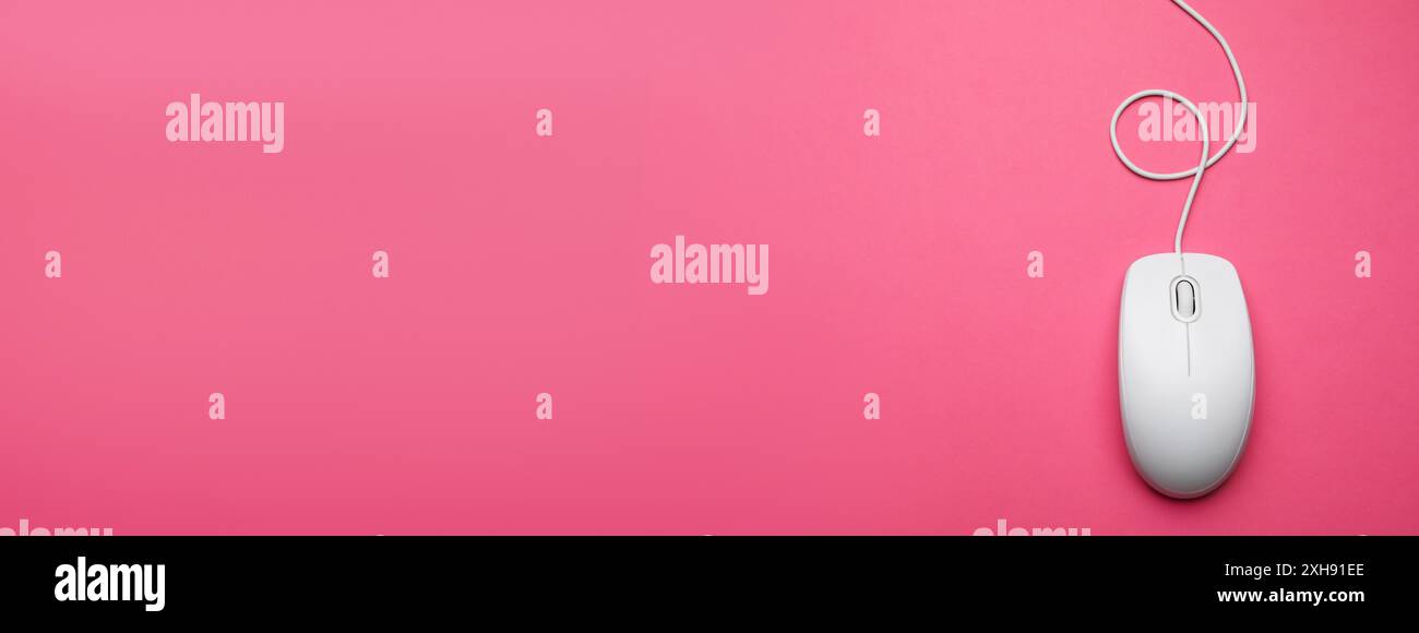 Computer mouse on pink background, top view. Banner design with space for text Stock Photo