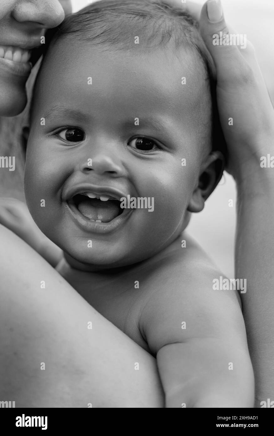 Close up portrait of mother hugging multiracial baby. Mom hug Biracial ...