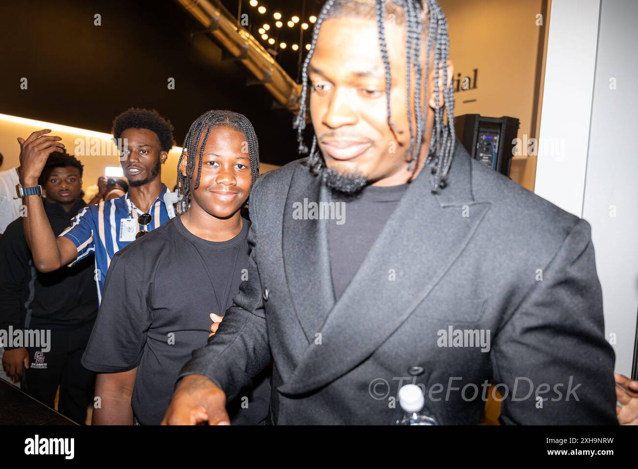 Newark, New Jersey, USA. 12th July, 2024. AL-QUADIN MUHAMMAD, jr, left with his father AL-QUADIN, Sr. after receiving Newark's Key to the City at the prudental lounge in Newark. NJ Muhammad born in Newark was drafted in 2017 by the Saints in the sixth round. He played for them in 2017, the Indianapolis Colts from 2018 to 2021, and the Chicago Bears in 2022. He re-joined the Colts in 2023. (Credit Image: © Brian Branch Price/ZUMA Press Wire) EDITORIAL USAGE ONLY! Not for Commercial USAGE! Credit: ZUMA Press, Inc./Alamy Live News Stock Photo