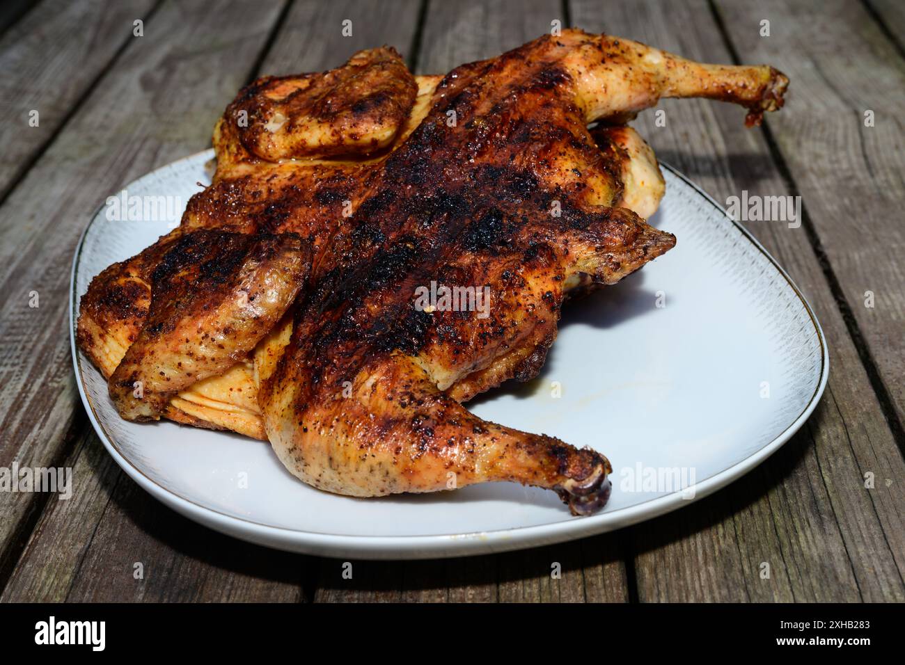 Pollo alla Diavola Whole Spatchcocked Italian Grilled Hot Chicken Seasoned with Peperoncino Chili Stock Photo