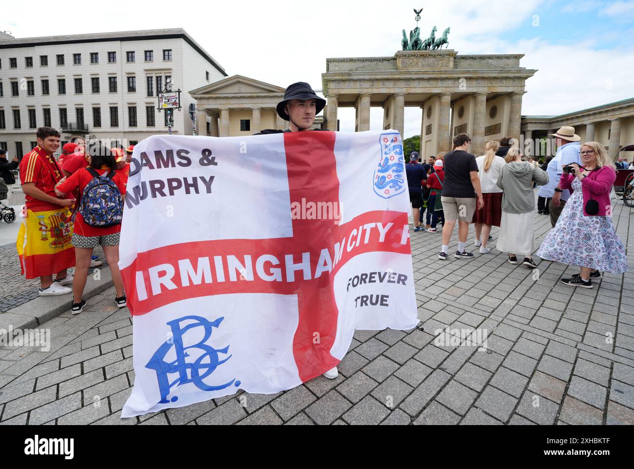 An England fan holds up a flag as he joins fans as they gather next to ...