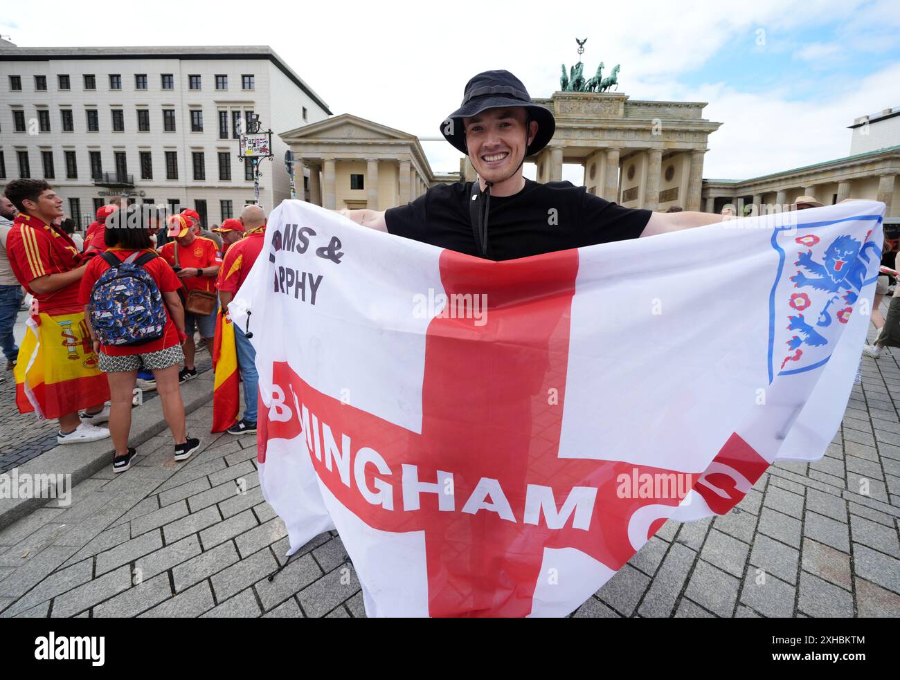 An England fan holds up a flag as he joins fans as they gather next to ...