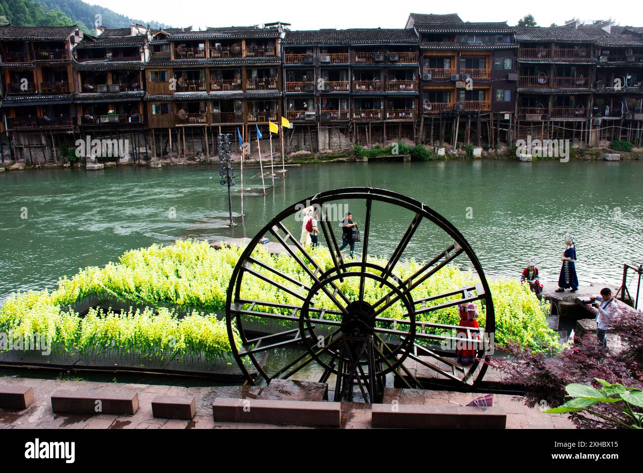 Ancient buildings wood turbine baler or antique architecture wooden water wheels chinese style tuojiang river of Xiangxi Phoenix Ancient City Antique Stock Photo