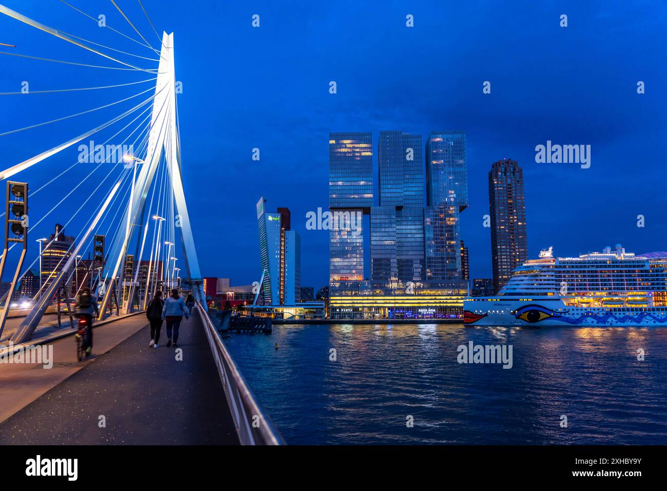 Rotterdam, skyline at the Nieuwe Maas, Erasmus Bridge, skyscrapers at the 'Kop van Zuid' district, cruise ship 'Aida Prima at the Cruise Terminal, Net Stock Photo