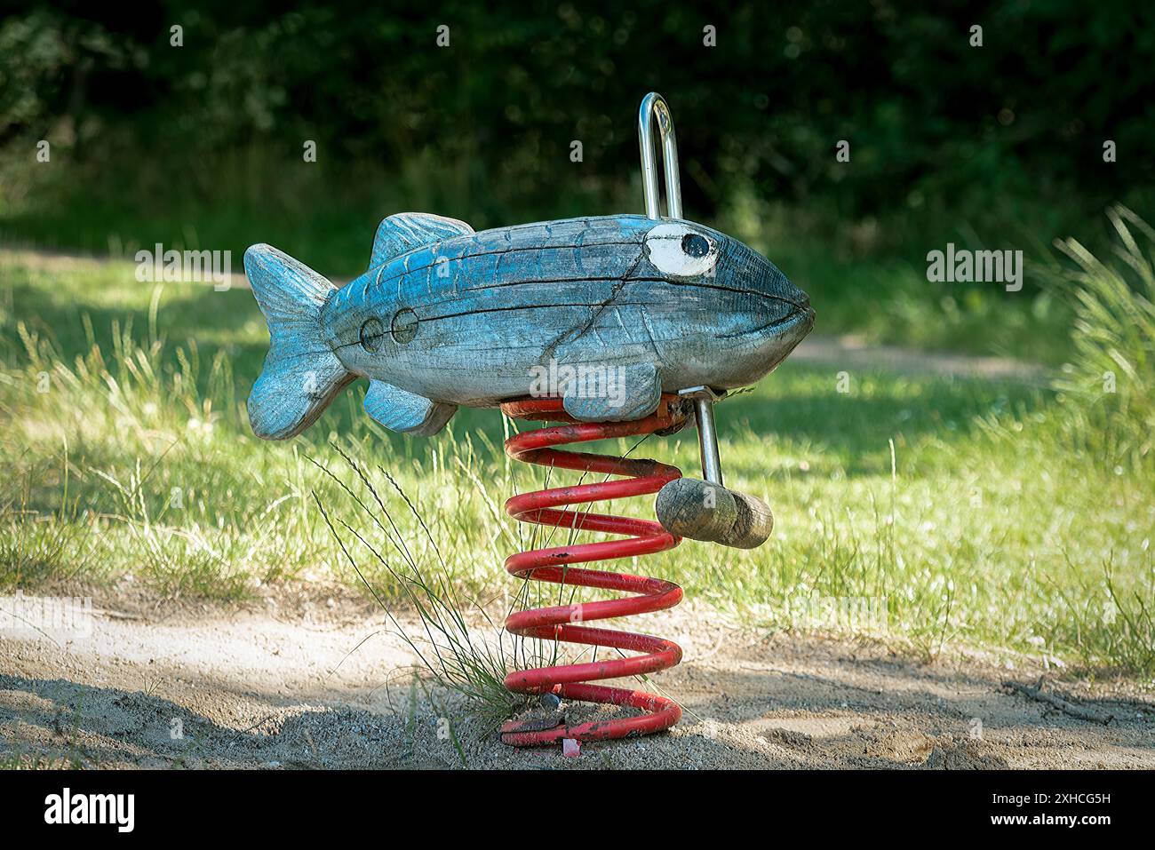 Wooden hand crafted fish spring rocker in a playground Stock Photo - Alamy