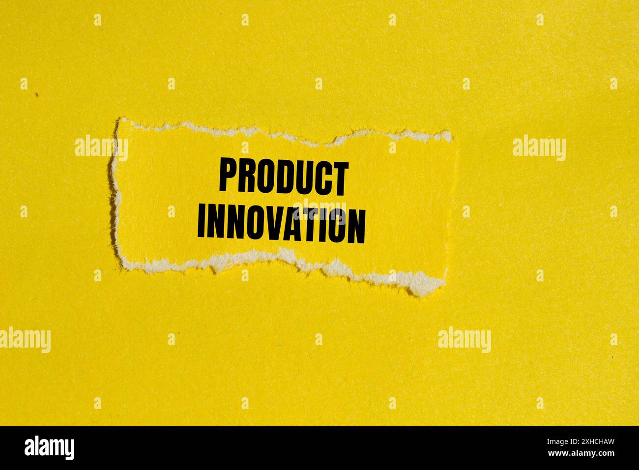 Product innovation message written on ripped paper piece with yellow ...