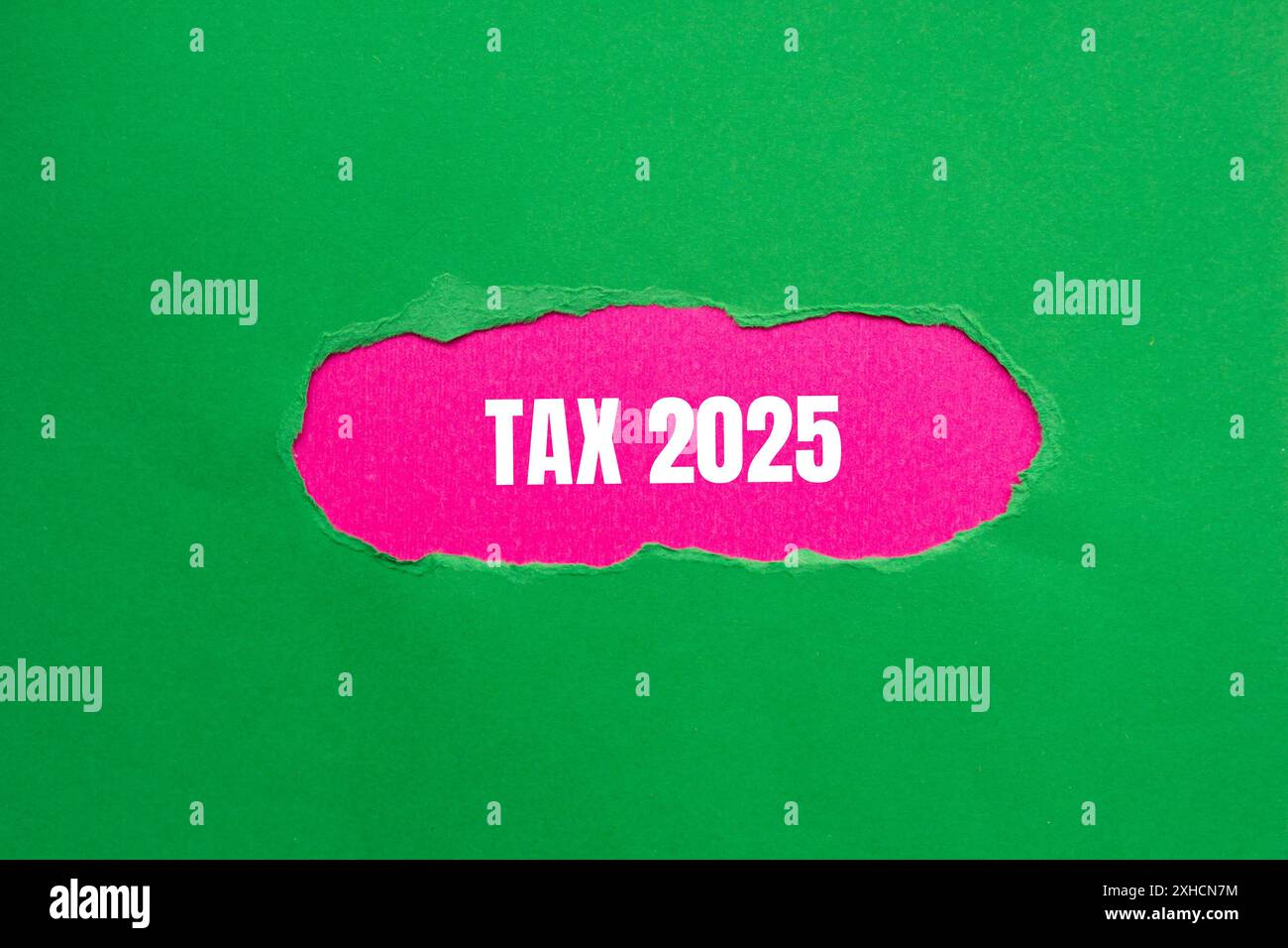 Tax 2025 message written on ripped green paper with pink background. Conceptual tax 2025 symbol