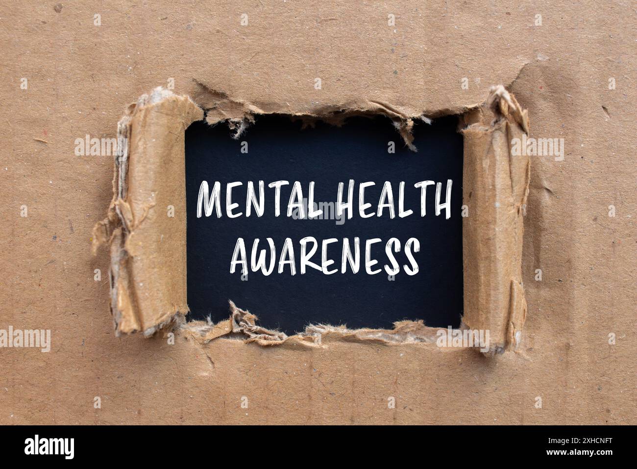 Mental health awareness message written on ripped cardboard paper with ...