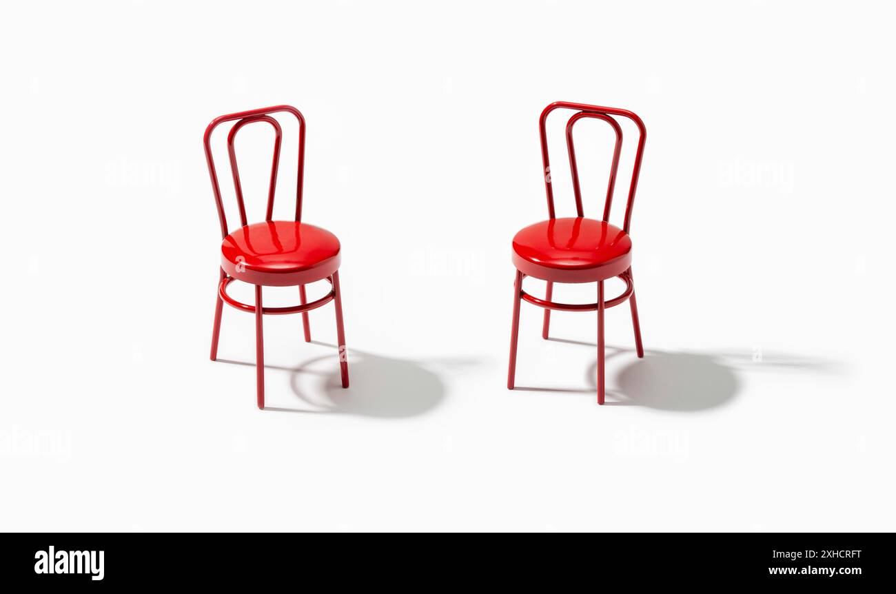 Two red chairs isolated on white background. Support or assistance concept Stock Photo