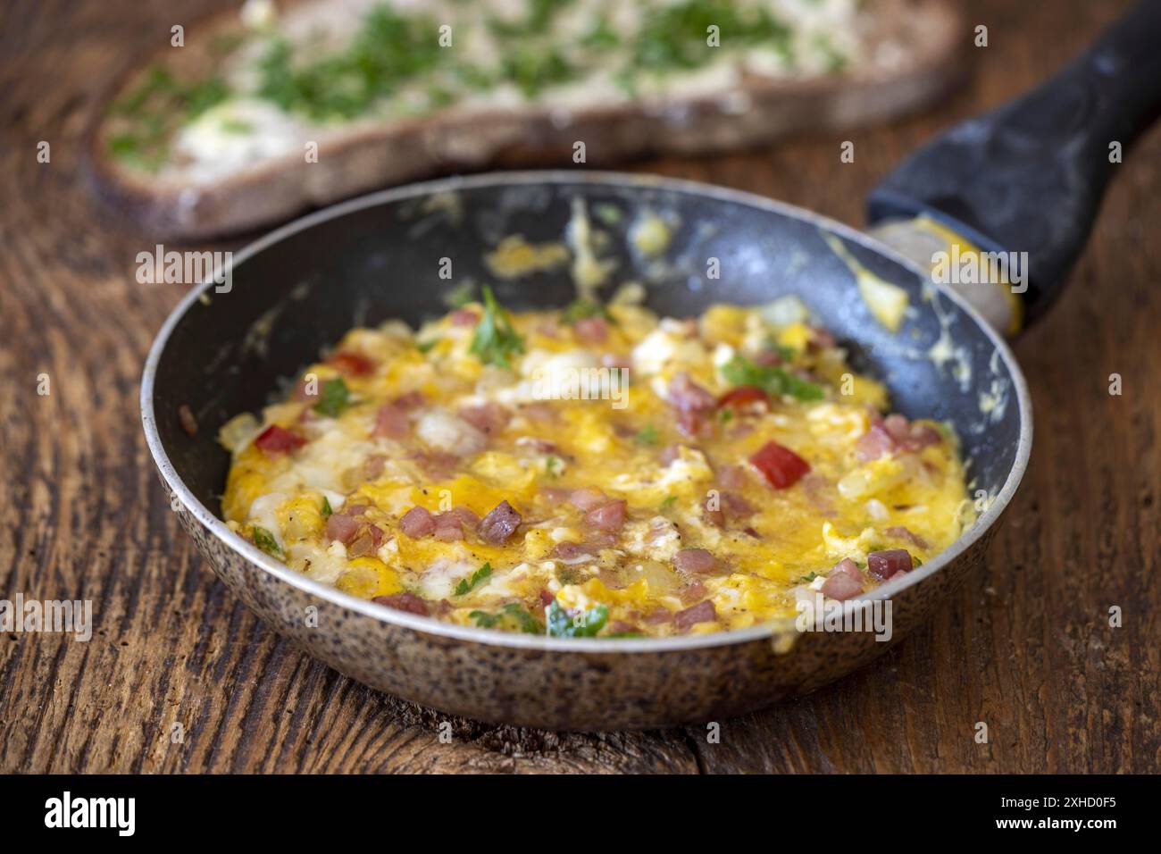 Scrambled eggs in a pan on wood Stock Photo
