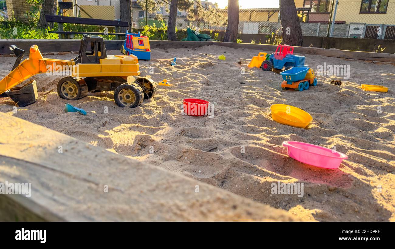 Sandbox outdoor. Children's wooden sandbox with various toys for the ...