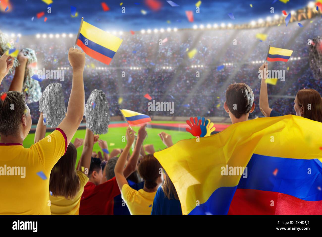 Colombia football supporter on stadium. Colombian fans on soccer pitch watching team play. Group of supporters with flag and national jersey cheering Stock Photo