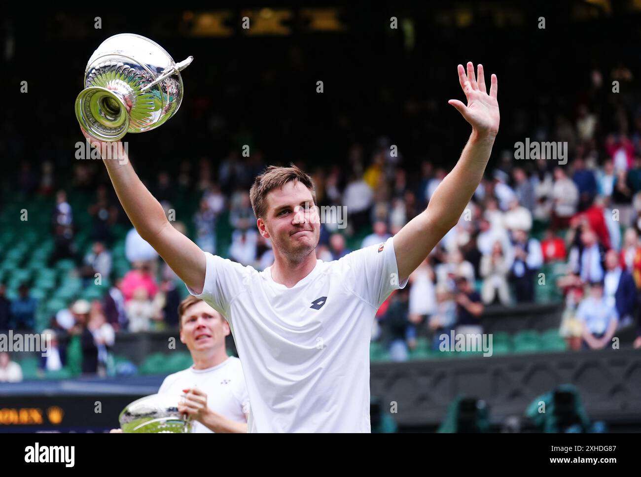 Henry Patten celebrates with the trophies after his victory over Max ...