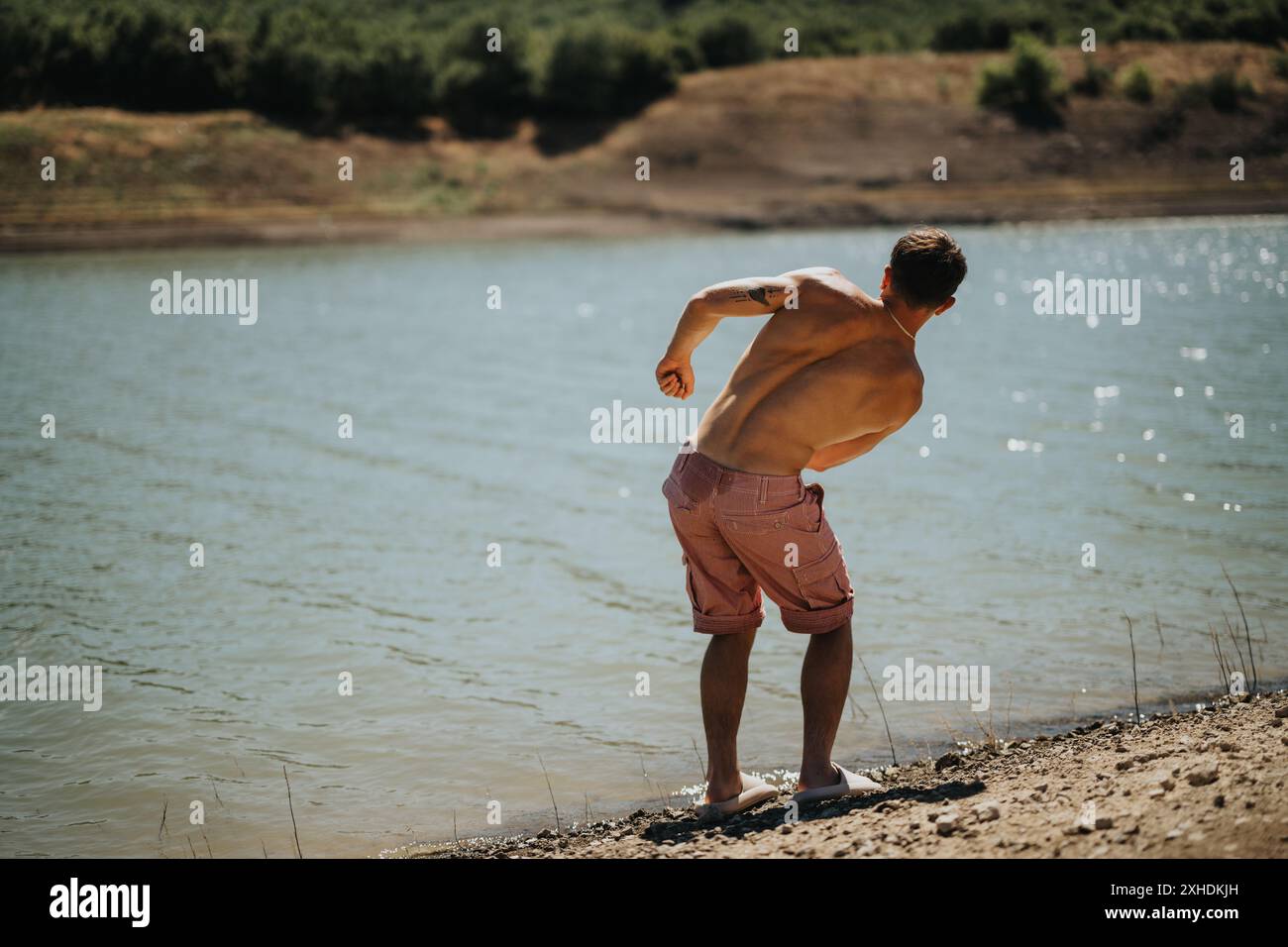 Young man skipping stones on hi-res stock photography and images - Alamy