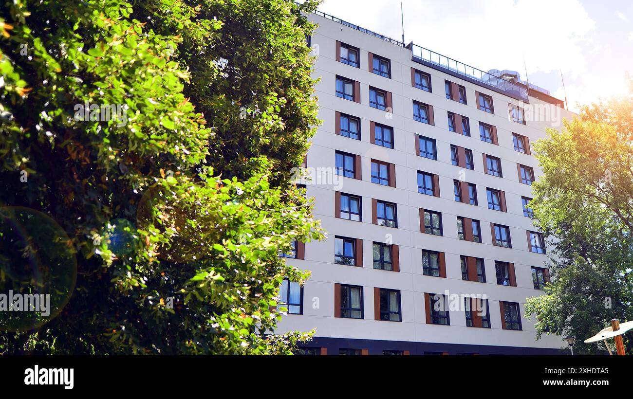 Modern residential building with new apartments in a green residential ... - Green Apartment Home Builders