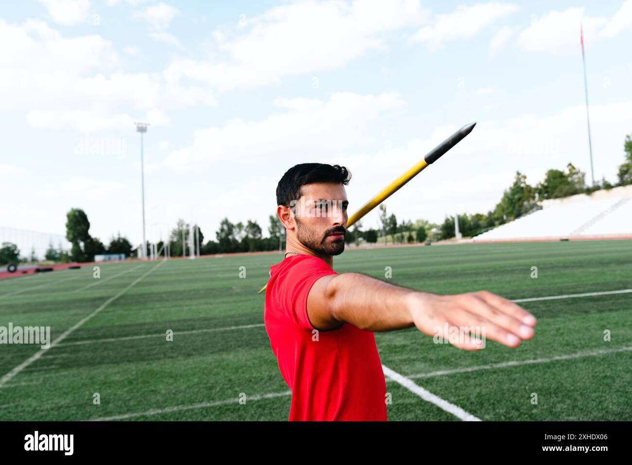 Male athlete throwing javelin at stadium Stock Photo