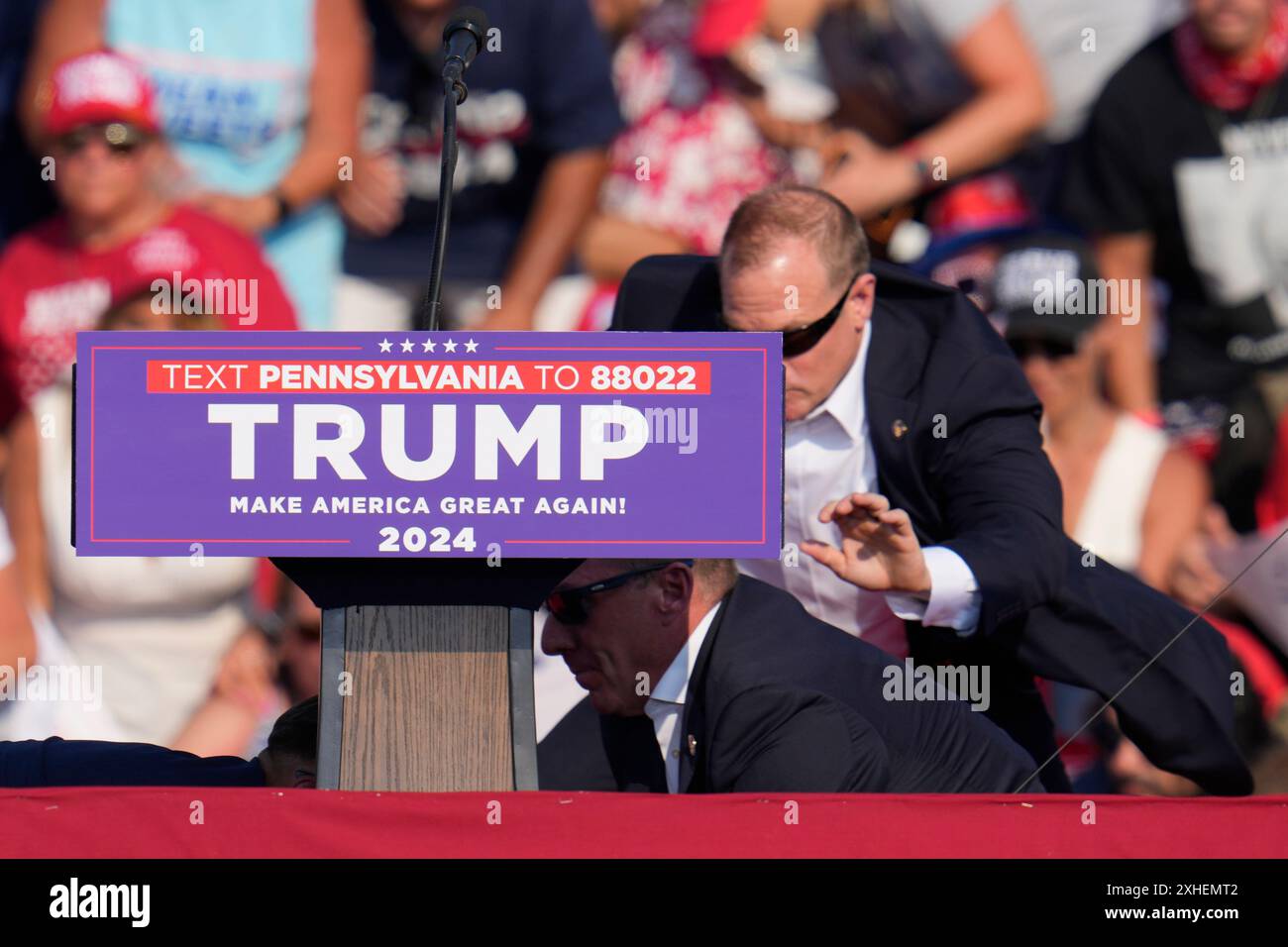 U.S. Secret Service agents surround Republican presidential candidate former President Donald Trump at a campaign event in Butler, Pa., on Saturday, July 13, 2024. (AP Photo/Gene J. Puskar) Stock Photo