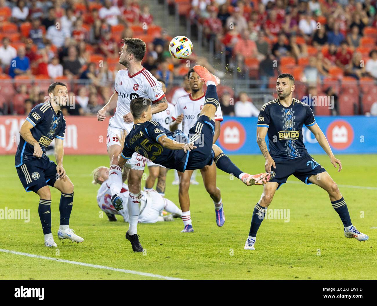 Toronto, Canada. 13th July, 2024. Chris Donovan (front) of Philadelphia Union makes a bicycle kick during the 2024 Major League Soccer(MLS) match between Toronto FC and Philadelphia Union at BMO Field in Toronto, Canada, on July 13, 2024. Credit: Zou Zheng/Xinhua/Alamy Live News Stock Photo