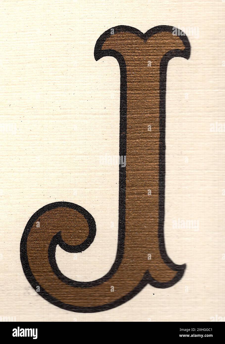 A decorative antique capital letter J in gold with a black outline on a ...