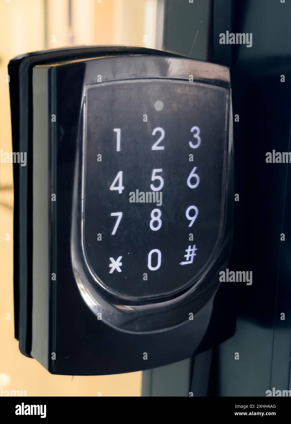 A close-up of a black keypad door lock with a numerical keypad. Stock Photo