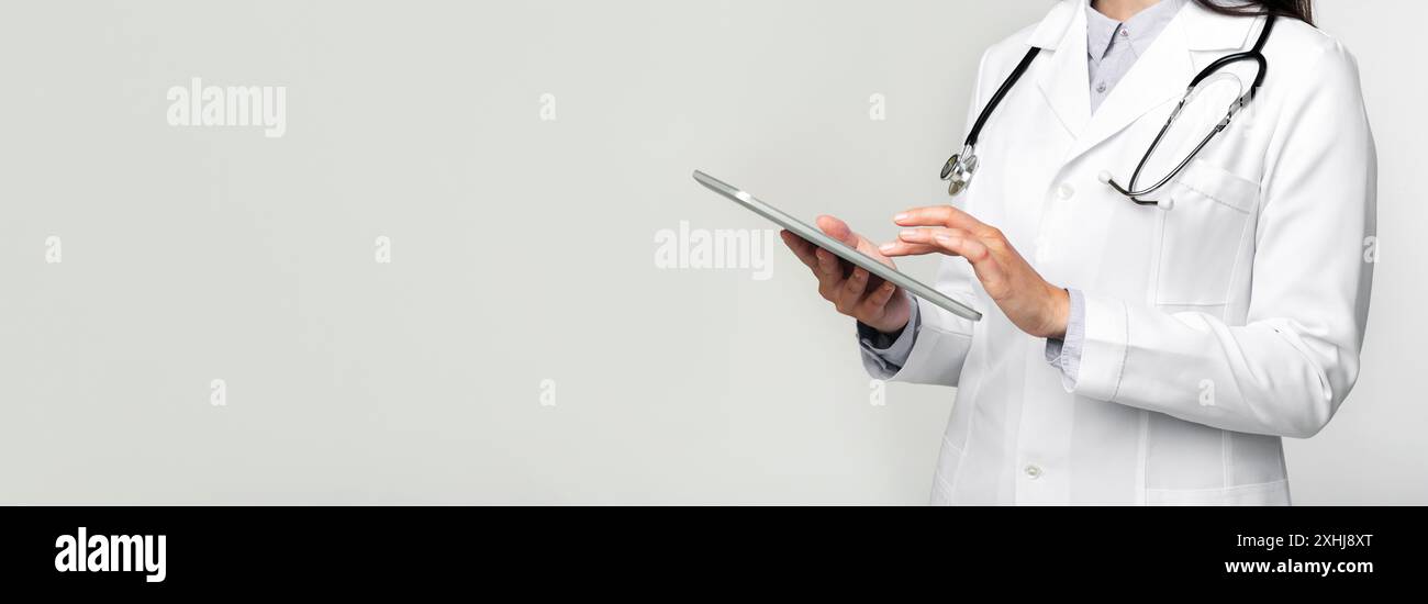 Unrecognizable Doctor Using Digital Tablet On White Stock Photo