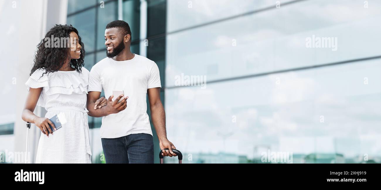 Couple Walking Through Airport With Luggage and Boarding Pass Stock ...
