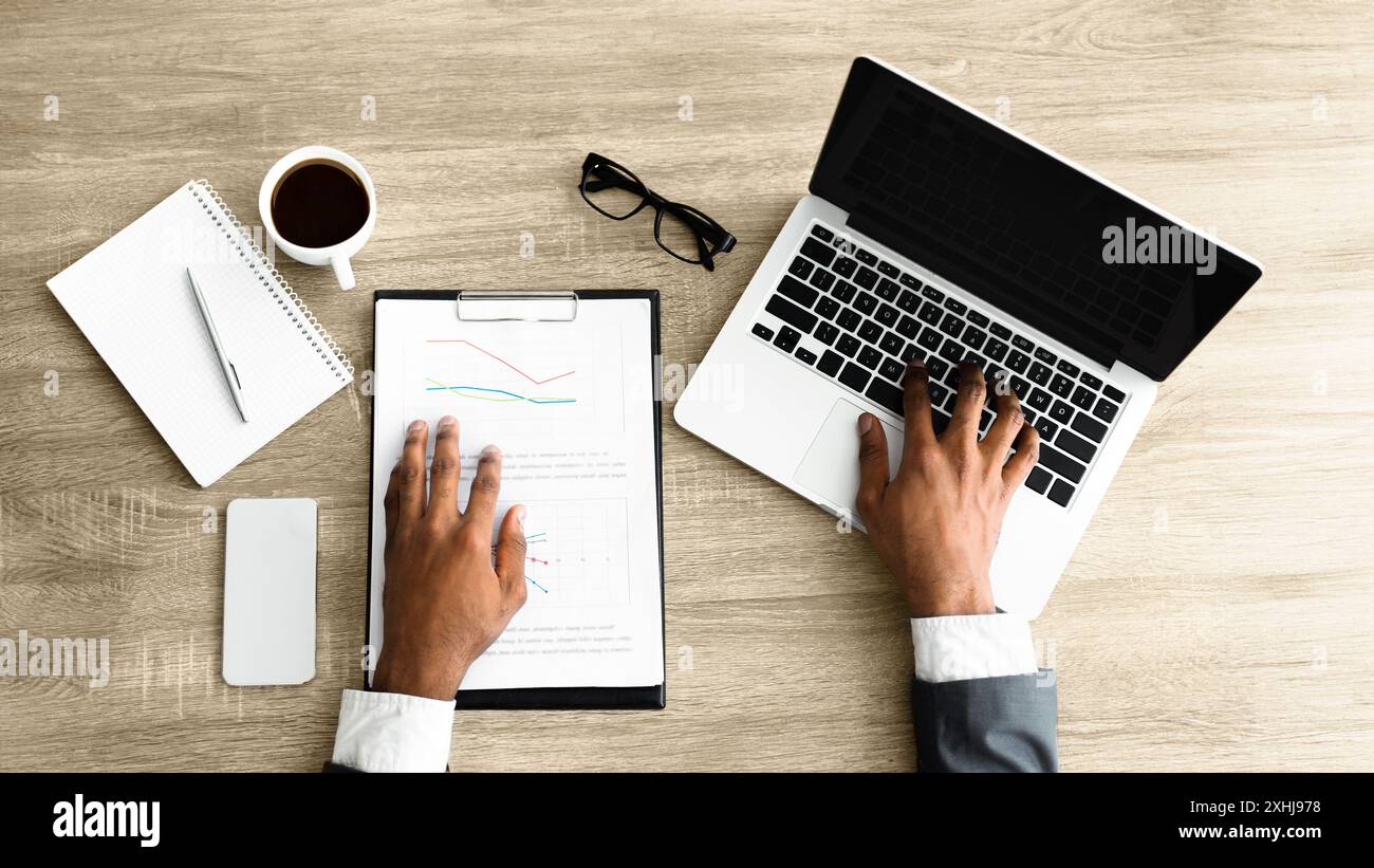 Businessman Working on Laptop and Documents Stock Photo