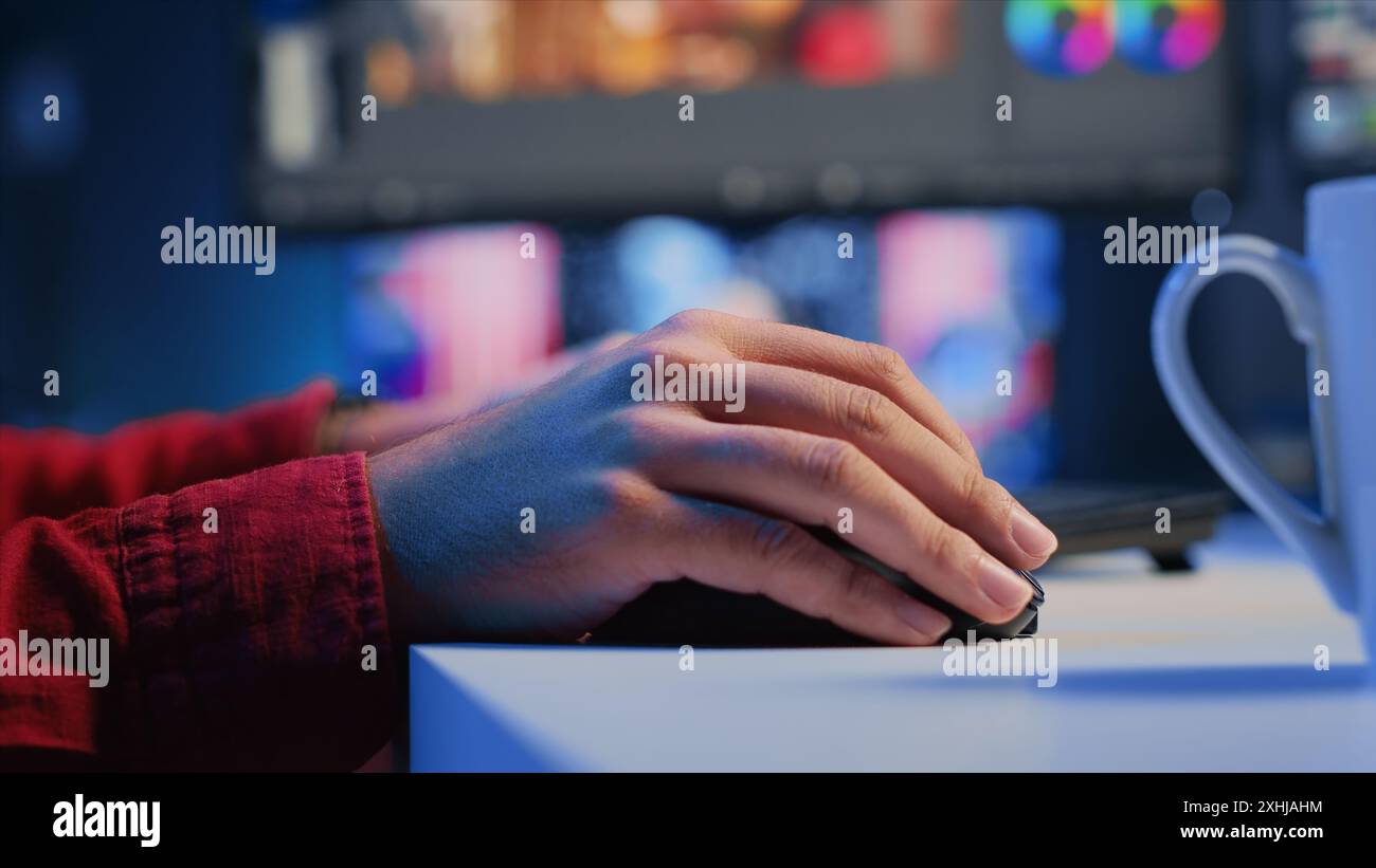 Extreme close up shot of video editor selecting key frames to use while doing video montage, working from home on computer. Man using mouse to edit movie project footage in office Stock Photo