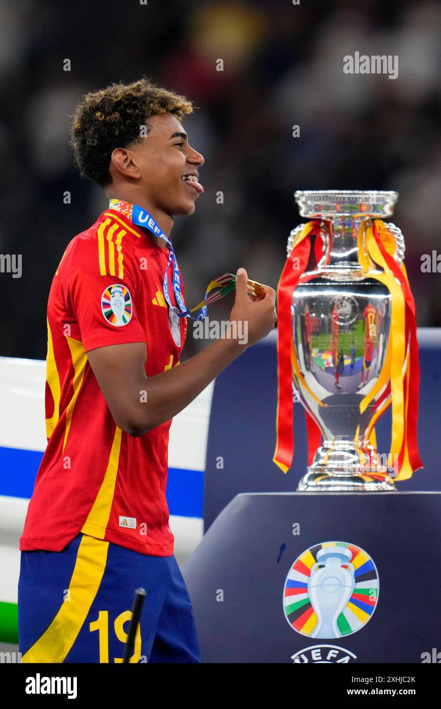 Spain's Lamine Yamal smiles with his medal next to the trophy after