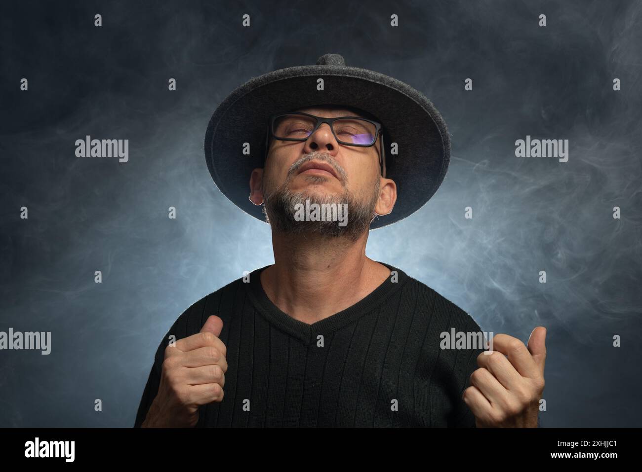 Portrait of man with beard and sunglasses and hat posing for ...
