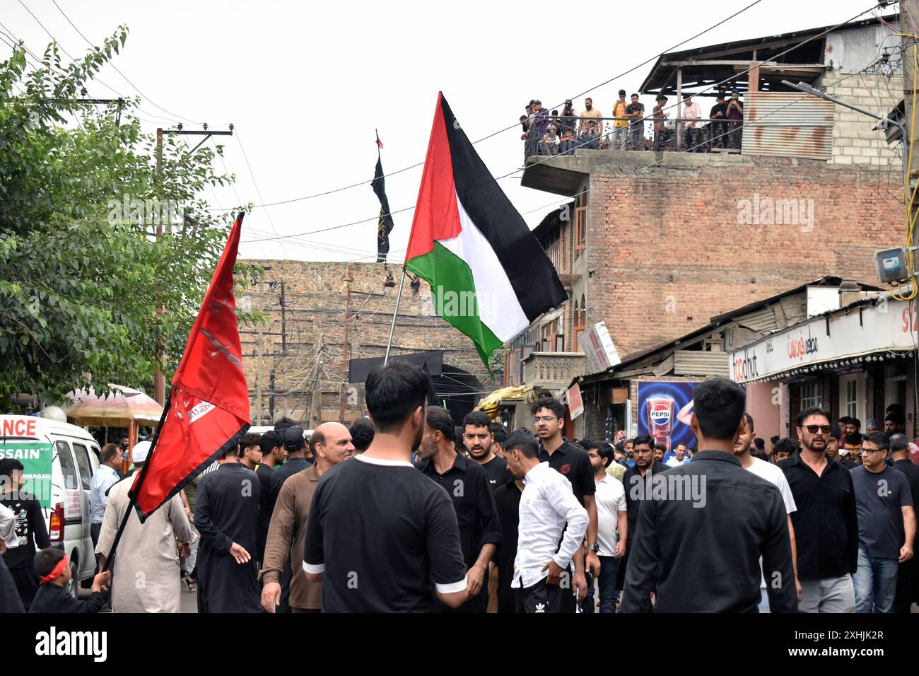 Srinagar, India. 14th July, 2024. A Kashmiri Shiite muslim waves a ...