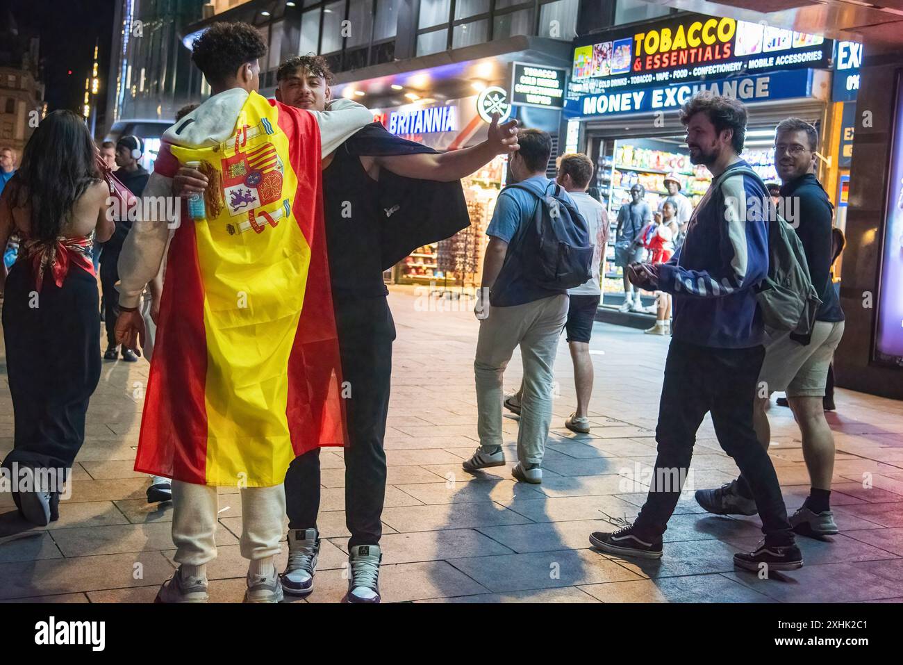 London, UK. 14th July, 2024. A football fan wrapped with the Spanish flag  celebrates after the Spanish team won during the UEFA EURO 2024 final match  between Spain and England. Spanish national