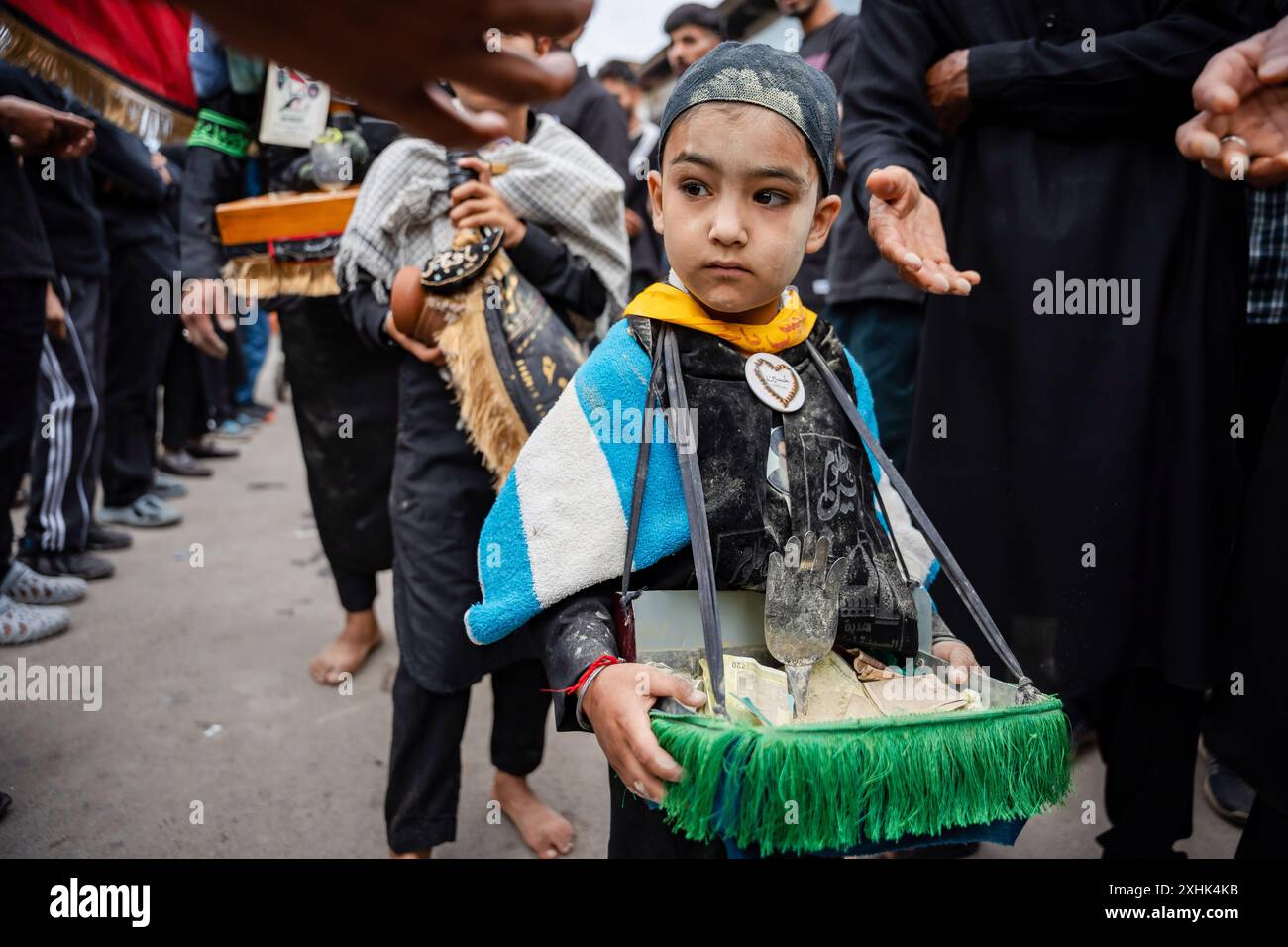 Srinagar, India. 15th July, 2024. A Kashmiri Shia Muslim boy, his face ...